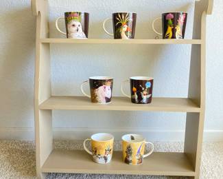 Three-Tier Wooden Shelf with seven Vicky Sawyer Art Coffee Mugs
