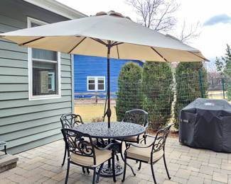  Round Black Iron Patio Table Set with 4 Chairs, Cushions, and Beige Umbrella 48" Diameter