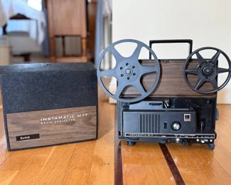 This item is a vintage Kodak Instamatic M77 movie projector, designed for home use with Super 8 and standard 8mm silent films. 