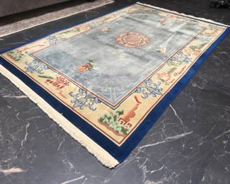 75” x 48” MCM hand made wool oriental rug.

Denim blue interior with vibrant navy blue and cream edges with Chinese architecture motif. Some staining on rug consistent with age, rug has been recently steamed and sanitized.