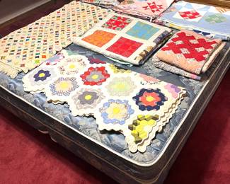 Several quilts in various condition levels