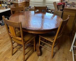 #29	round oak pedestal table with 4 wood chairs48x29	 $140.00 