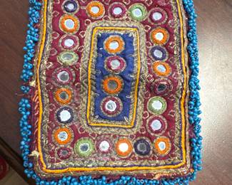 vintage hand-embroidered textile from the Kutch region of India opens to a small bag 