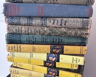 Stack of antique hardcover books, vintage cloth covers