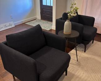 Living room with pair of dark accent chairs and round side table