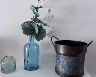 Blue glass bottle vase with faux flowers, galvanized metal bucket
