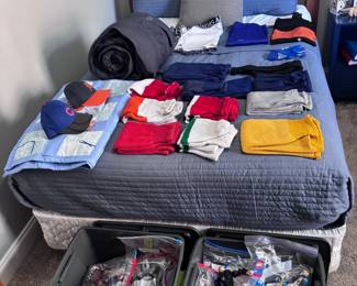 Boys clothing lot, folded on bed and in storage bins