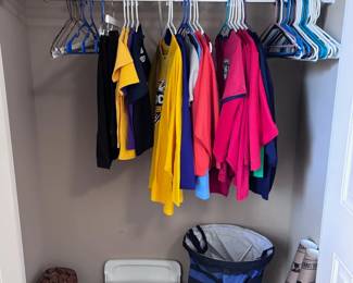 Boys closet with polo shirts, trophies, sports bags