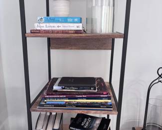 Industrial bookshelf with books, DVDs, and glass vases