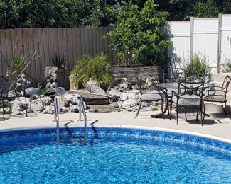 Numerous patio table and chair sets, wicker side tables, loungers, and benches.