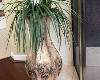 One of two large vases with artificial plant.