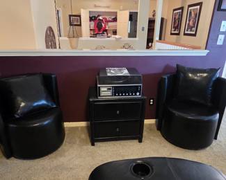 2 black leather swivel chairs.  Stand and stereo for sale also.