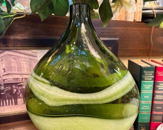 Decorative hand blown art glass  green bottle vase featuring white swirls 