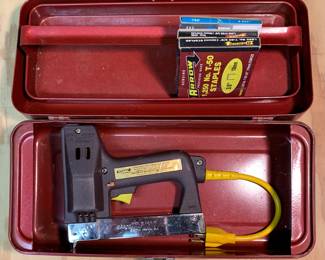 Electric staple gun with four packs of various sized staples.