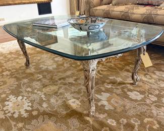 Glass coffee table on carved wood base