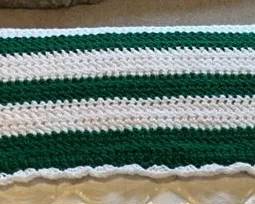 Handmade forest green and ivory crocheted afghan throw blanket featuring intricate vertical stripes 