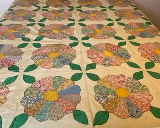 Vintage handmade Dresden Plate quilt, featuring colorful floral patchwork petals arranged in a circu