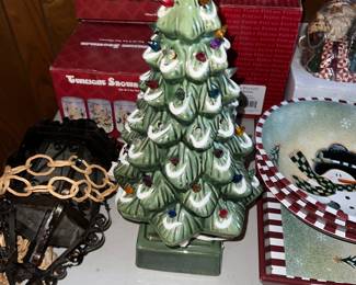 Vintage green ceramic Christmas tree with snow-capped branches and lights