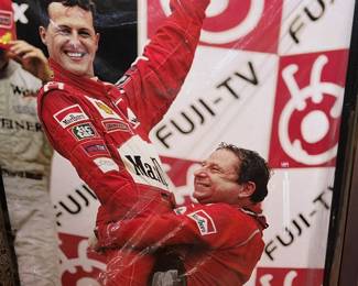 Picture of iconic moment in Formula 1 history featuring Michael Schumacher and Jean Todt celebrating