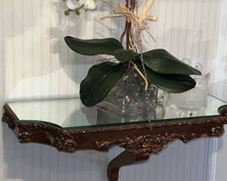 White phalaenopsis orchid arrangement on a Rococo styled carved wall mount console table with mirrored top