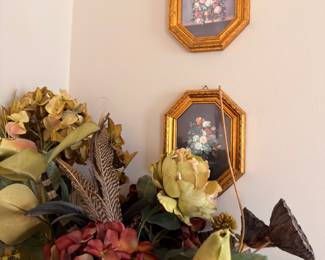Gold-framed floral prints, silk flower arrangements