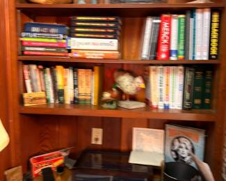 Books, vintage collectibles, figurines on bookshelf