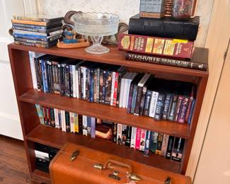 Wooden bookshelf, crystal punch bowl, vintage leather suitcase