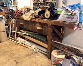 Large wooden workbench, tools, sewing machine, extension cords
