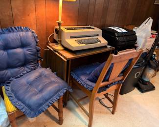 Vintage typewriter, printer, cushioned wooden chairs