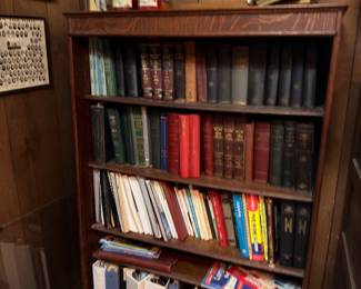 Wooden bookcase with book collection, leather-bound volumes