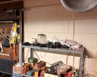 Garage workshop with shop light, tools, and shelving