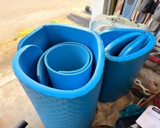 Blue foam pool noodles and exercise mats