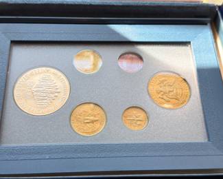Commemorative gold and silver coin set in framed display case