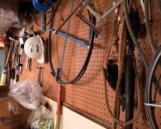 Pegboard with assorted hand tools and garden tools