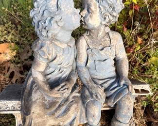 Concrete garden statue, kissing children figurine