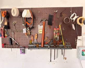 Pegboard hand tools, scissors, tape, workshop supplies