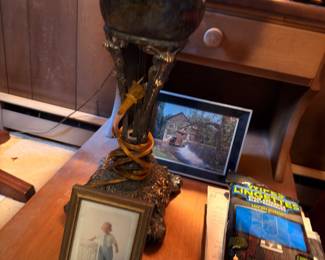 Antique brass oil lamp, framed photos, desk accessories