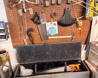 Metal toolbox, pegboard hand tools, workshop equipment
