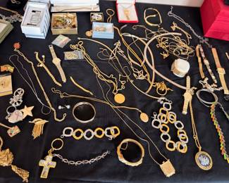 Gold tone jewelry lot: watches, bracelets, crosses, chains, lockets, bangles