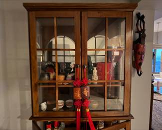 Wooden corner curio display cabinet, designed to showcase collectibles and decorative items $995