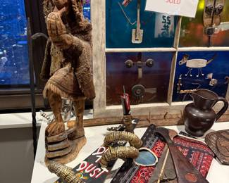 Andean folk art carved from wood, including a rough-woven tunic and a distinctive knit ear-flap hat (ch'ullo), $80 