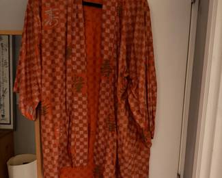 This orange and red checkered vintage garment is a traditional Japanese haori jacket, a shortened style of kimono worn as a light outer layer $150