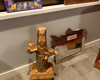 Carved & Painted Fish Frame $30, 'Man-Log' Figure (Carved log figure, on floor) one-of-a-kind piece of folk sculpture, hand-carved from a single log $85, Unique fish-topped mirror, textured metallic frame with a rustic, galvanized finish that complements the rusted patina of the fish $70