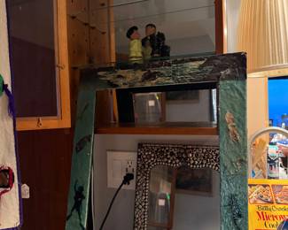 Handcrafted Mixed-Media Nautical Mirror Frame, finished in a textured teal-blue wash and embellished with three-dimensional sea shells, starfish, and aquatic-themed appliqués,  Approxx Approximately 30" H x 24" W  $85.00 |  Beaded Inlay Mirror, Condition: Excellent pre-owned condition; all beadwork and stones appear intact. Dimensions: Approximately 12" H x 10" W $70 