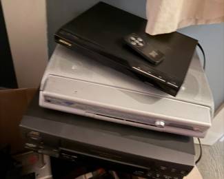 Top: Sony DVP-SR210P DVD Player Appears well-maintained; untested, includes a small, slim remote control $44, Middle: Philips LX7000SA Home Cinema System.  This unit functions as both a DVD/SACD player and a multi-channel surround sound amplifier. $60,   Bottom of stack: JVC Super VHS (S-VHS) VCR,  features a front-loading tape slot, a bright digital display, and "Easy TBC" or similar video stabilization features common to this JVC line $200 