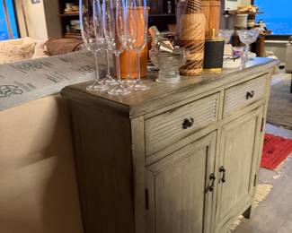 Safavieh Tate 2-Drawer, 2-Door Sideboard, versatile storage unit designed with a mix of farmhouse and coastal aesthetics. Appearance: Pine wood, Distressed Grey, Hardware: It is detailed with simple, dark metal pewter-finished knobs, 29.5" wide x 13.4" deep x 26" high, Condition: Used, Like New, Price $350