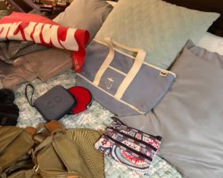 Christian Dior (CD) Grey Hardshell Case $310, Green ballistic nylon with full-grain brown leather accents and trim $85, LeSportsac Paisley Accessory Pouch multi-colored paisley pattern with multiple dark-brown zippered compartments $70 "People" Anchor tote bag $40,  