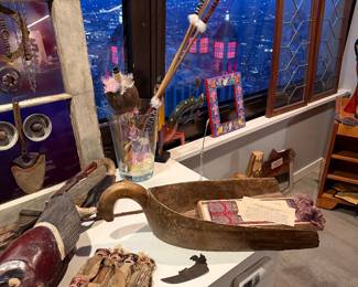 large, hand-carved "boat-shaped" vessel with a distinctive curved handle. Likely used historically for dough or grain, it shows a rustic patina and includes internal items like vintage papers. $60