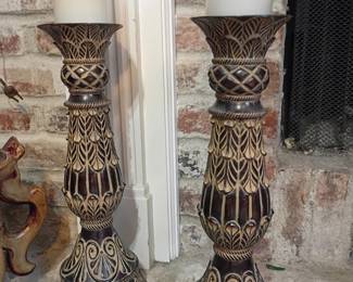 Large ornate pillar candle holders, carved decorative candlesticks, white candles, fireplace decor
