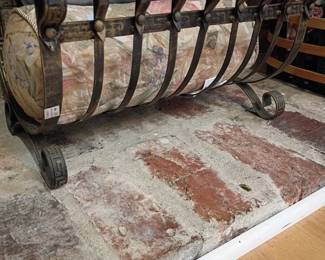 Wrought iron fireplace log holder grate and rolled area rug